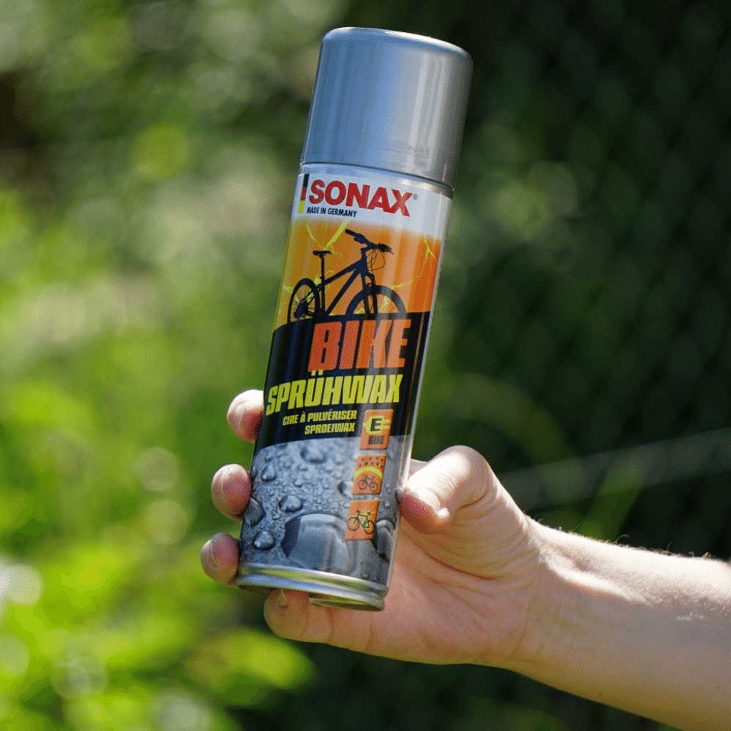 image of SONAX bike polish wax in mans hand 